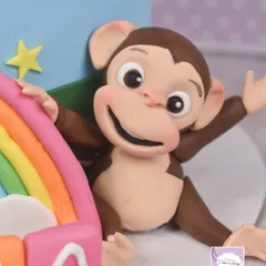 A close-up of the monkey figurine from the Cocomelon cake.