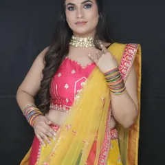 This multi-colored lehenga in pink, yellow, and green is the perfect outfit for a Haldi or Mehndi ceremony. It's bright, festive, and fun.