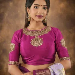 For a truly royal look, the model wears a heavily embellished blouse with a statement neckline. The matching oversized earrings complete the ensemble, making it perfect for a wedding.