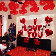 This is a classic romantic room decoration I do for anniversaries and surprises. It includes 'I LOVE YOU' foil balloons, a fairy light backdrop, heart-shaped balloons, and balloons on the ceiling.