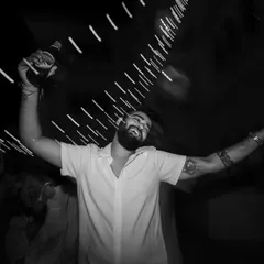 The pure euphoria of the party. This motion-blurred, black and white shot captures a guest celebrating with abandon, reflecting the wild energy of the night.