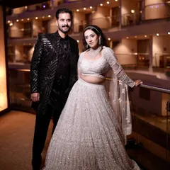 A full-length shot of the couple. The bride's showstopper look was both grand and perfectly suited to her personality.
