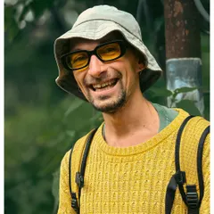 The bright smile of a man I met on my travels, captured in a candid moment. His yellow sweater and bucket hat add to the cheerful and friendly nature of this stranger portrait.