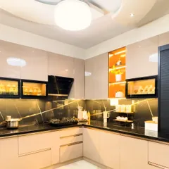 We believe a kitchen should be as beautiful as it is functional. This modular kitchen design features high-gloss laminate cabinets, a striking black marble backsplash, and integrated lighting to create a workspace that is both efficient and inspiring.