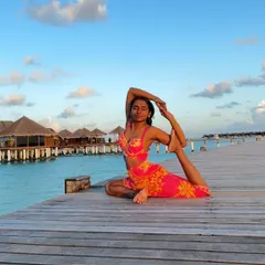 A photo dump from the Maldives, featuring a beautiful Eka Pada Rajakapotasana (One-Legged King Pigeon Pose) on a pier.
