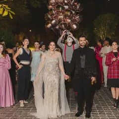 The couple's entry for their Parisian-themed cocktail night was a spectacle in itself, accompanied by mimes, performers, and a balloon-carrying singer to create a whimsical, street-theatre feel.