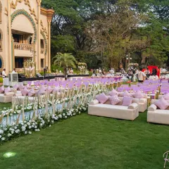 A closer look at the guest seating for the anniversary gala. I used a combination of comfortable sofas with plush cushions for VIP sections and neatly arranged chairs, separated by a floral aisle, to create a luxurious and organized layout.