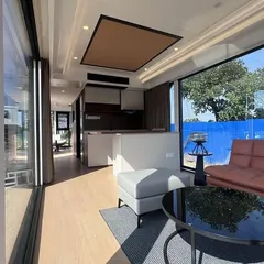 Step inside one of our innovative Space Capsule homes. This interior view shows a fully-equipped, modern living area with large windows that connect you to the outdoors, all within a compact and efficient design.