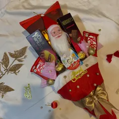 My most unique Secret Santa gift: the Christmas Bouquet. This fun and festive arrangement is built inside a plush Santa hat and filled with a variety of chocolates.
