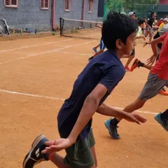 A young athlete mid-stride during a running drill. Proper running mechanics are a fundamental skill for any sport.