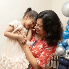 A sweet, candid hug between a mother and daughter during a birthday celebration. These are the priceless memories I strive to capture.