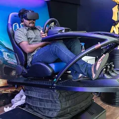 A guest experiences the thrill of our VR driving simulator. The professional-grade racing seat and motion platform provide haptic feedback, simulating every turn and bump for a truly immersive motorsport experience at your event.