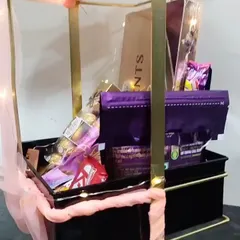 A close-up look inside the metal bow hamper, showing the variety of chocolates included. It's a perfect gift for any occasion that calls for a sweet celebration.