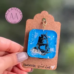 A custom Adiyogi keychain with a blue marble effect, created to match a client's cherished Shivji frame.