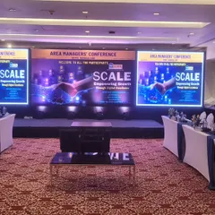 This is our setup for an Area Managers' Conference, featuring a U-shaped seating arrangement for better interaction. We provided a three-panel LED video wall for a wide, immersive presentation experience.