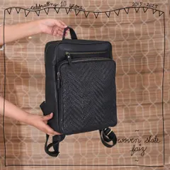 The Faiz backpack in our Woven Slate edit. The hand-woven front pocket adds a touch of texture and sophistication to this classic, functional leather backpack, making it perfect for work or weekend trips.