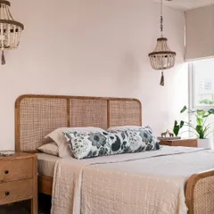 We believe bedrooms should be serene retreats. In the Aqua Home, we used a soft blush palette, a cane bed, and beaded chandeliers to create a calm, laid-back space that still feels elevated and special.