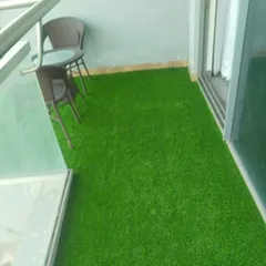 Another angle of the Noida balcony, showing the neat installation of the artificial grass.