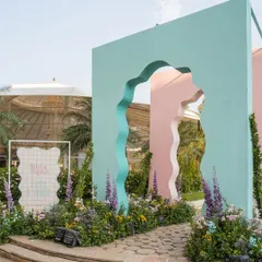The whimsical entrance to our 'Côte d'Amour' mehendi, featuring wavy, pastel-colored arches that set a playful and artistic tone.