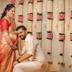 A classic, heartwarming moment between expecting parents during their traditional baby shower ceremony. We love capturing these sweet, unscripted interactions, like the dad-to-be listening to his baby against the backdrop of a lovely floral wall.