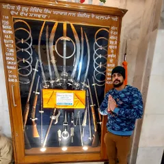 Here I am before the historic weapons of Guru Gobind Singh Ji. My Sikh faith is a source of immense strength and discipline in my life.