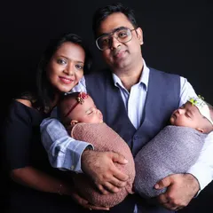 Capturing double the joy with a beautiful studio portrait of parents holding their newborn twins. I have experience posing and photographing twins to create cherished family keepsakes.