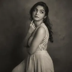 This black and white portrait of Mridula is pure vintage elegance. Her pose, looking away from the camera, combined with the soft, painterly light, creates a dreamy and nostalgic mood. The lace detail on her dress is beautifully rendered in monochrome.