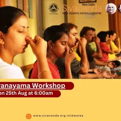 Students in a Pranayama workshop practicing Anulom Vilom, or alternate nostril breathing. This fundamental technique is taught to help balance the body's energies and calm the nervous system.