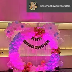 A modern and stylish backdrop for a corporate party celebrating a "New Beginning". I used a circular balloon arch in shades of pink and purple, with spotlights to make it pop for photos.
