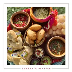 The ultimate Chatpata Platter, designed for lovers of tangy and spicy Indian street food. This platter is loaded with favorites like chole bhature, golgappe, and dahi bhalla, garnished with pomegranate and fresh herbs.