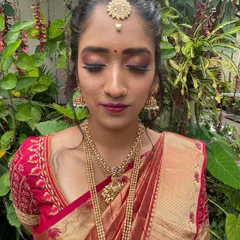 A detailed shot of the eye makeup for this traditional look. The blend of deep red and shimmer creates a dramatic effect that is perfect for festive occasions.