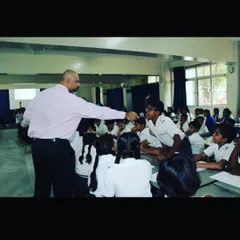Personal attention is key. In this photo, I am working with a student during an interactive session. I make it a point to engage with each child, providing gentle corrections and encouragement to help them find their voice and build confidence.
