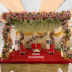 For this outdoor wedding, I designed a breathtaking floral mandap that felt both grand and natural. The canopy is lush with pastel roses and hanging white wisterias, creating the perfect sacred space for pheras under the open sky.