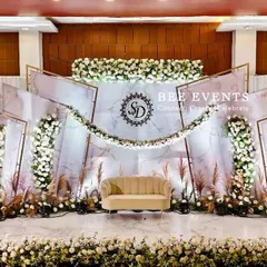 We specialize in creating modern and elegant reception stages that leave a lasting impression. This setup features a chic white and gold theme with a marble-finish backdrop, personalized monogram, and lush floral arrangements.
