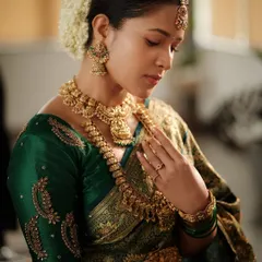 The beauty of traditional temple jewellery is timeless. This close-up shows the intricate details of the Lakshmi pendant choker and kasina sara (coin necklace), a classic choice for South Indian brides.