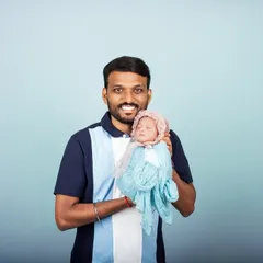 A proud father holds his newborn baby for the first time in the studio. Capturing these early moments of bonding is one of the most rewarding parts of my job.