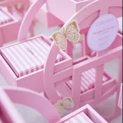 A closer look at the details of our bespoke baby announcement gifts. The delicate butterfly accent adds a touch of whimsy to these custom pink rocking horse boxes.