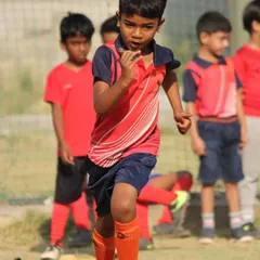 A snapshot from our football summer camp, capturing a player's determination as he works on his speed and footwork.