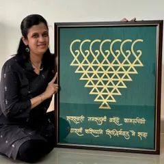 Here I am with a large, custom-made Saraswati frame. This piece, featuring the sacred yantra and shloka, was created to bring blessings of knowledge and peace to a client's home. I can customize the size and colors to perfectly match your space.
