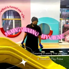 Team Skadoosh in action. Here, a staff member carefully cleans the big yellow slide, ensuring it is spotless and safe for the next round of fun.
