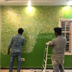Our team collaborating on a large green and yellow textured wall. We work together to ensure a consistent and beautiful finish across the entire surface.