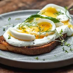 Our version of Turkish eggs on toast. Perfectly soft-boiled eggs sit on a bed of garlicky yogurt spread over our toasted sourdough, finished with dill and chili oil.