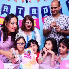 Making a birthday wish surrounded by friends and family. Our private party rooms provide an intimate space for these special moments.