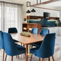 Here is how my tiles can bring a space together. This open-plan dining and kitchen area features a deep blue subway tile backsplash that adds a pop of color and texture, creating a sophisticated yet welcoming atmosphere for family meals.