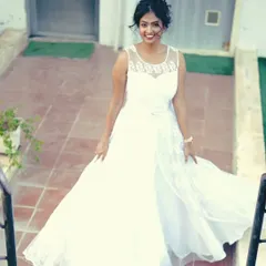 The flowing skirt of this white gown looks beautiful in motion, as seen in this shot from a staircase.
