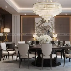 We designed this exquisite dining area for luxury and sophistication. A grand, multi-tiered chandelier hangs over a large round dining table, surrounded by elegant upholstered chairs, creating the perfect atmosphere for formal gatherings.