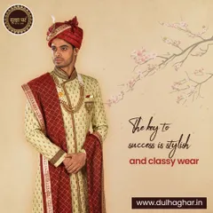 This ensemble is the key to a classy and successful wedding look. A beige sherwani with intricate embroidery is paired with a rich maroon safa and stole, creating a look of timeless royal highness.
