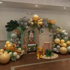 I bring magical worlds to life, like this "Wild One" safari adventure featuring Mickey Mouse. This large-scale backdrop combines custom cutouts, lush balloon garlands, and themed props to create an immersive experience for a child's special day.