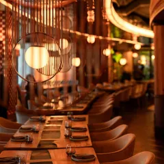 Our modern interior design features a mix of warm wood, metallic accents, and ambient lighting. This creates a sophisticated yet relaxed environment suitable for both formal corporate events and casual social gatherings.