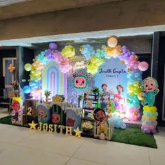 I bring popular cartoon themes to life for kids' birthdays. This Cocomelon party features character cutouts, a rainbow balloon arch, and themed props that make children feel like they've stepped right into their favorite show.